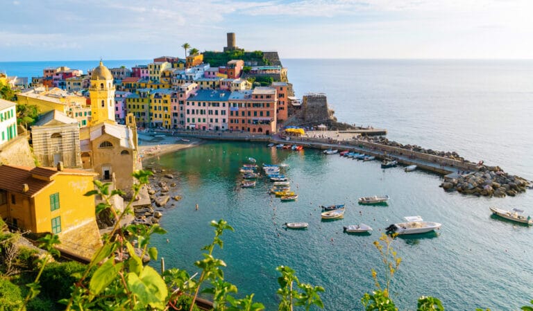 Vernazza, Cinque Terre National Park, Italy - Best Places to See in Italy with colorful buildings and boats on the coast