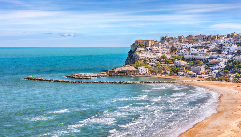 Stunning view of Peschici's wide sandy beach in Puglia, Italy, one of the best beaches in Italy.