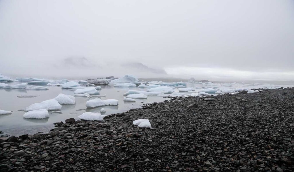 Icebergs floating in the glacier lagoon under cloudy skies – Best Time to Visit Iceland